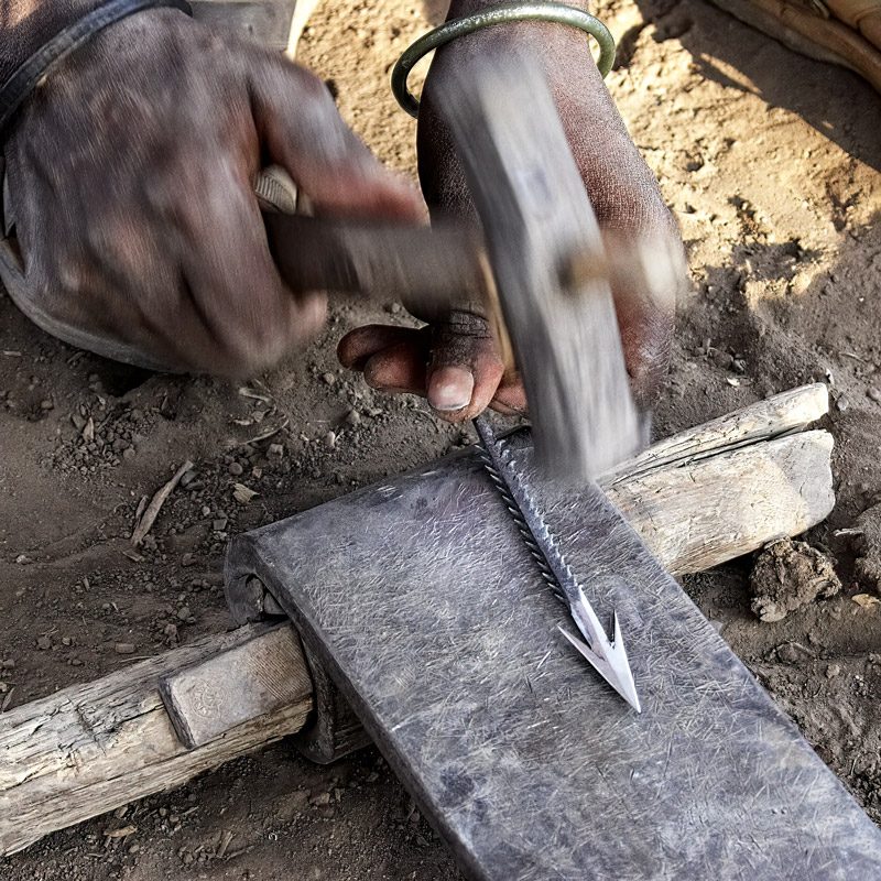 Datooga blacksmith melting metal