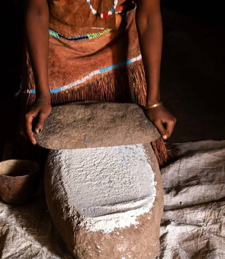 Datooga family grinding maize